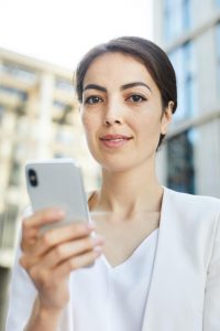 young-businesswoman-holding-smartphone.jpg